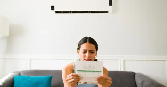 Woman looking at her electric bill