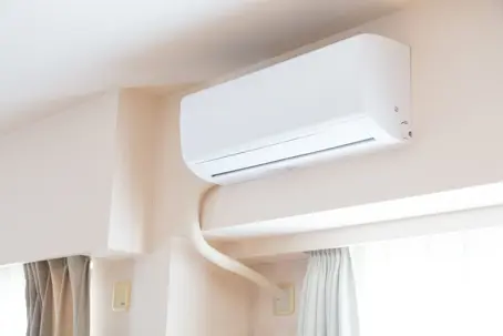 White home air conditioner on the white wall | Roadrunner Air